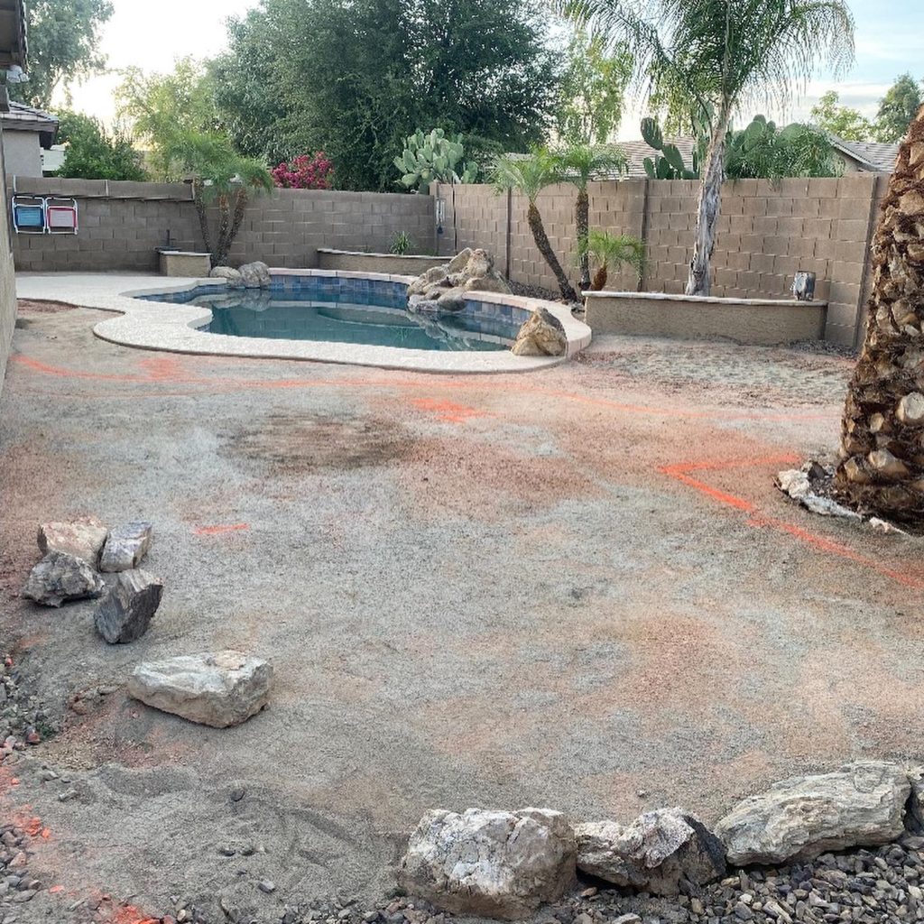 before image of a dirt yard with a pool being remodeled