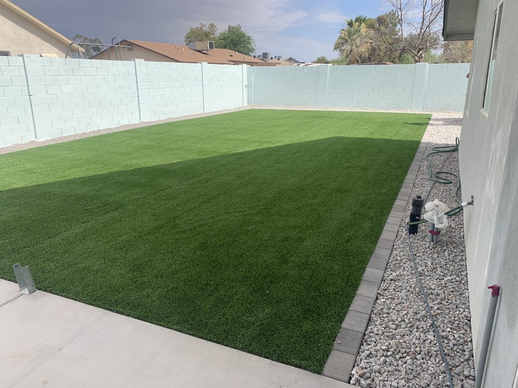 after picture of artificial turf, paver edges, and a patio extension