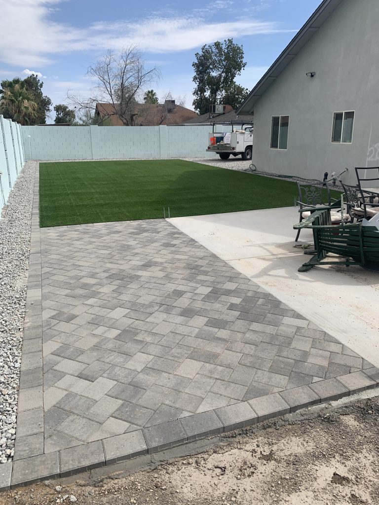 after picture of artificial turf, paver edges, and a patio extension