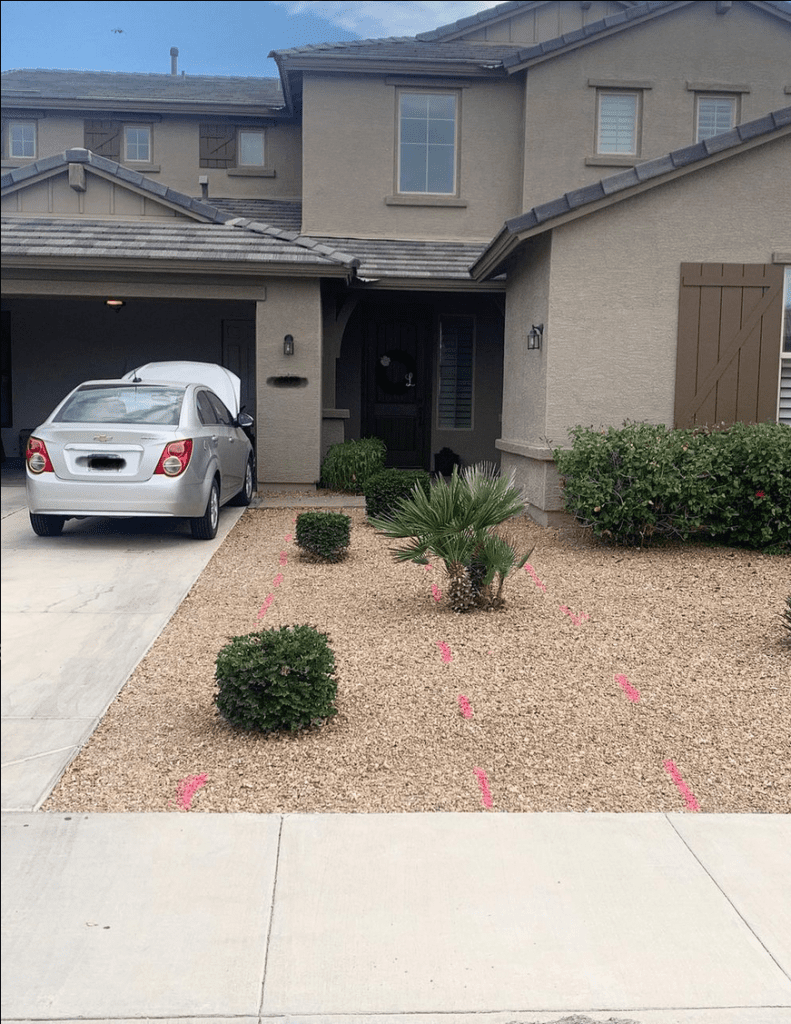 before image of a spray painted gravel path marked for pavers