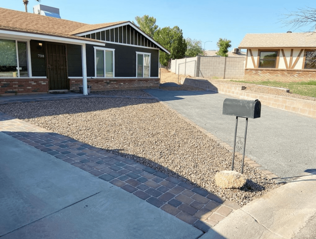 a yard that has paver driveway extension and walkway and new gravel