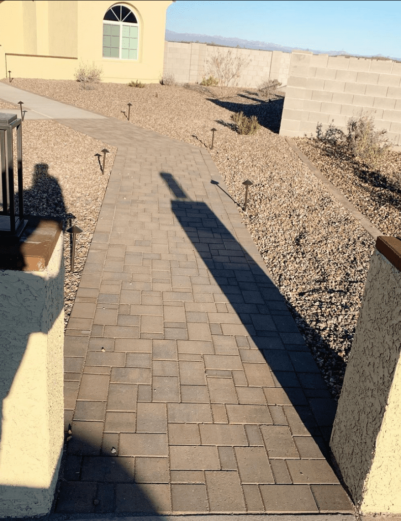 a brick walkway connecting the street to the front door