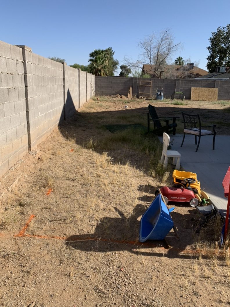 before a total yard transformation with dead grass and dirt and toys